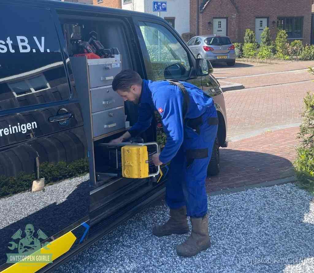 Een monteur pakt apparatuur uit de bedrijfsbus voor service aan huis, het moment om een professional in te schakelen voor een verstopte wc in Goirle